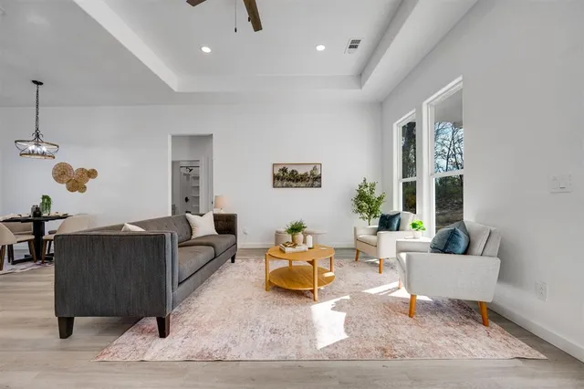 a living room with furniture and wooden floor