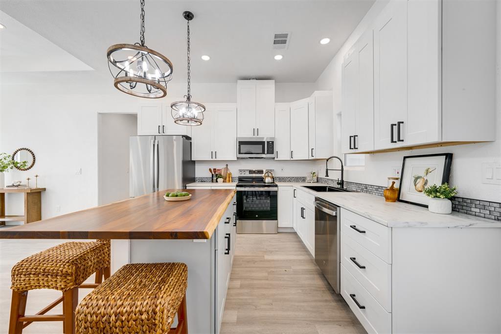 260 Private Road Sumner, TX 75486 - Photo 8 of 23 a kitchen with cabinets stainless steel appliances and a chandelier