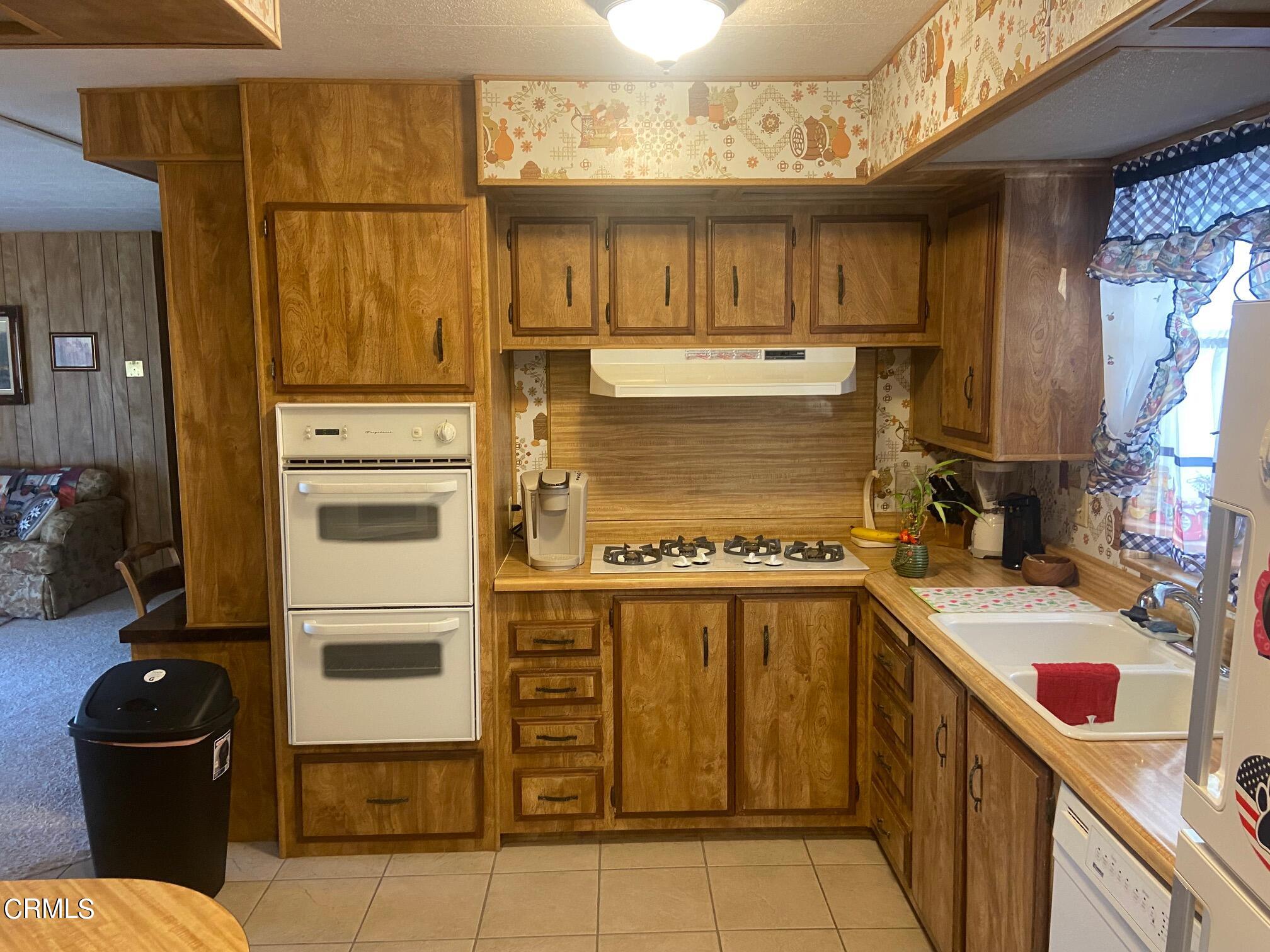 250 East Telegraph Road, Unit 76 Fillmore, CA 93015 - Photo 16 of 25 a kitchen with a refrigerator and a sink