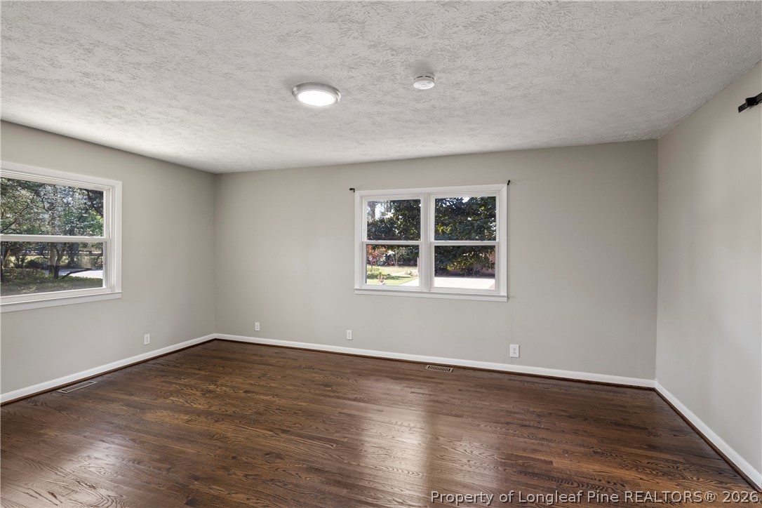 4196 Cliffdale Road Fayetteville, NC 28303 - Photo 14 of 38 a view of empty room with wooden floor and fan