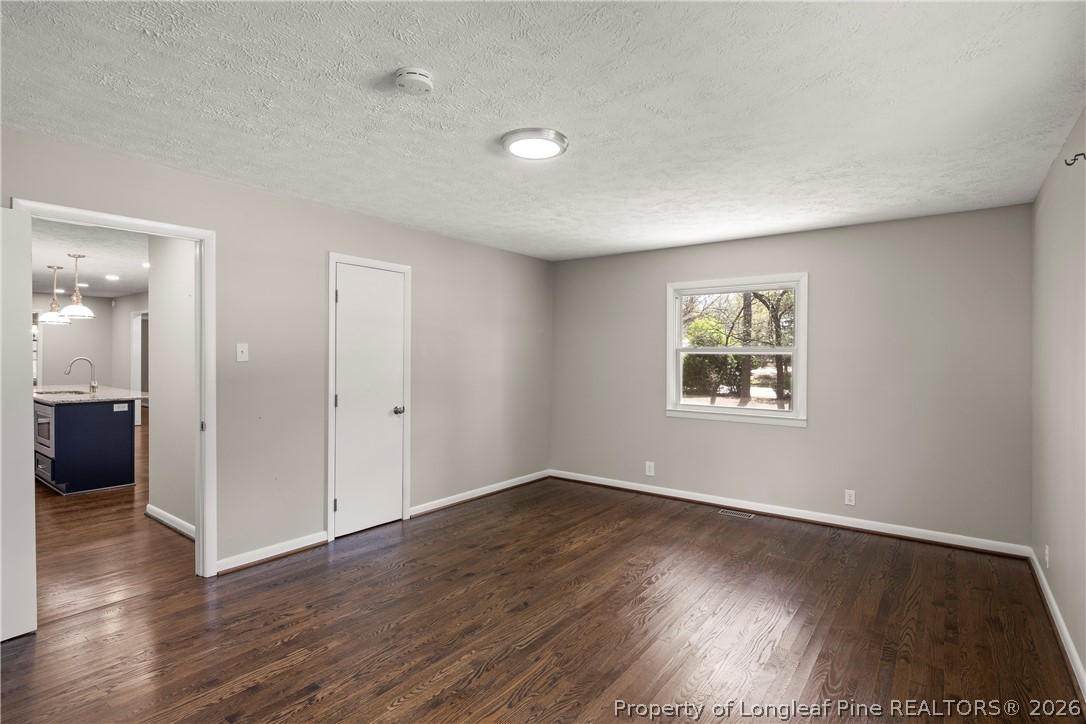 4196 Cliffdale Road Fayetteville, NC 28303 - Photo 15 of 38 an empty room with wooden floor and windows