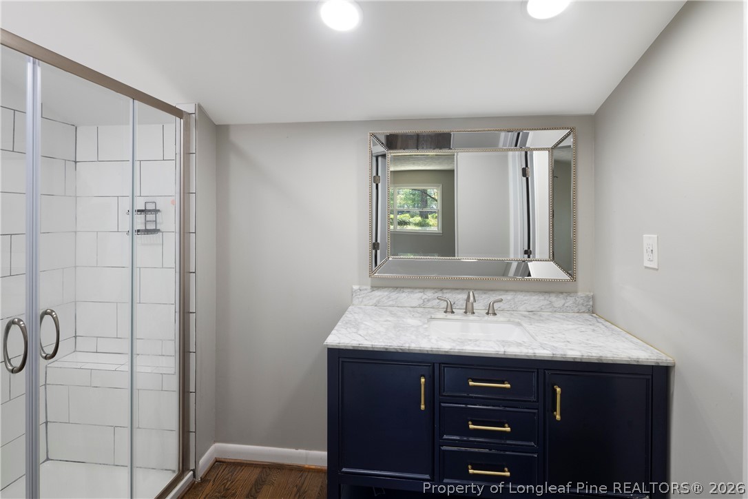 4196 Cliffdale Road Fayetteville, NC 28303 - Photo 17 of 38 a bathroom with a sink vanity and a mirror