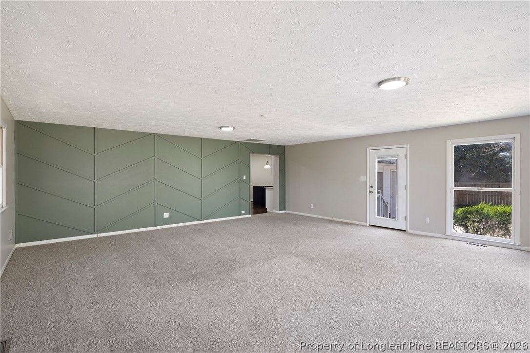 4196 Cliffdale Road Fayetteville, NC 28303 - Photo 22 of 38 a view of an empty room with window and stairs