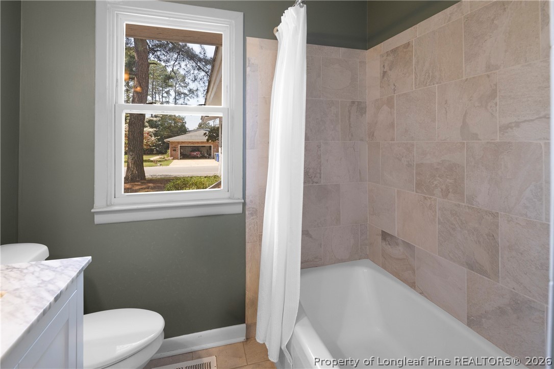 4196 Cliffdale Road Fayetteville, NC 28303 - Photo 27 of 38 a bathroom with a toilet and a shower