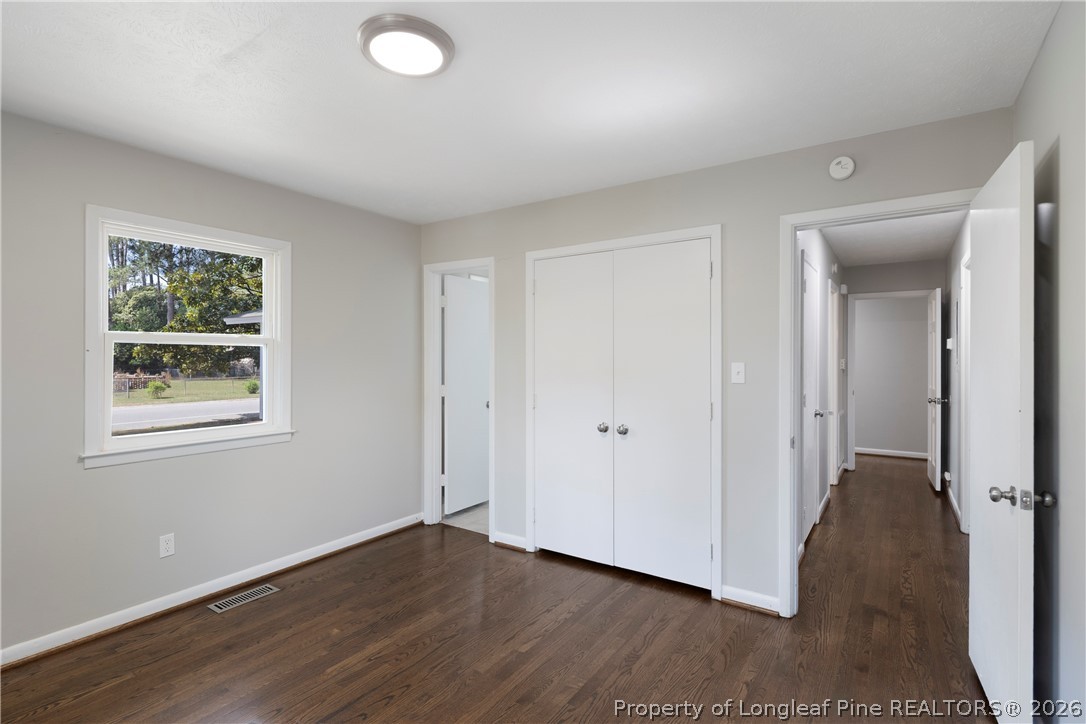 4196 Cliffdale Road Fayetteville, NC 28303 - Photo 28 of 38 an empty room with wooden floor and windows