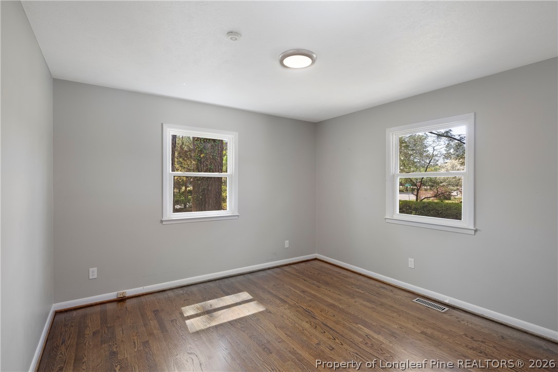 4196 Cliffdale Road Fayetteville, NC 28303 - Photo 34 of 38 wooden floor in an empty room with a window