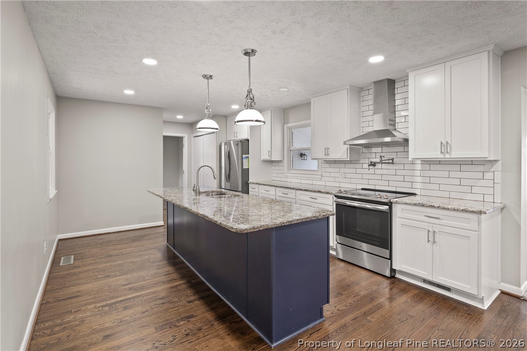 4196 Cliffdale Road Fayetteville, NC 28303 - Photo 10 of 38 a kitchen with kitchen island granite countertop a sink and a stove