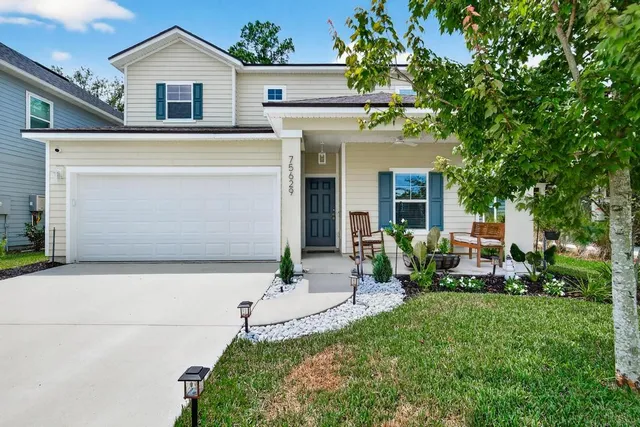 a front view of house with yard and outdoor seating