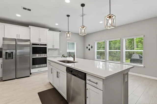 a bedroom with a bed a window and a chandelier