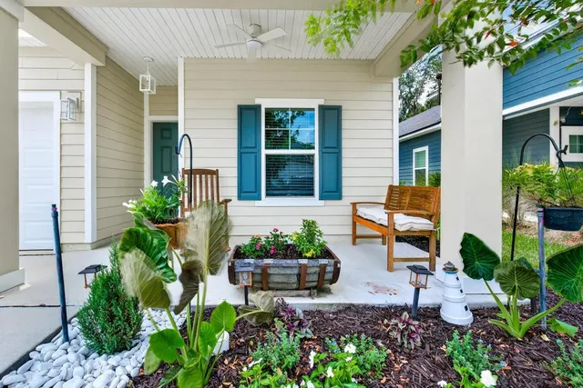 a front view of a house with outdoor seating and flowers