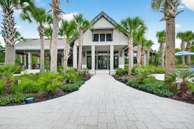 a view of a patio with a dining table and chairs under an umbrella