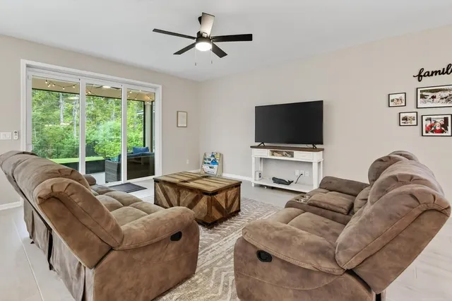 a kitchen with stainless steel appliances kitchen island granite countertop a sink a stove and a refrigerator