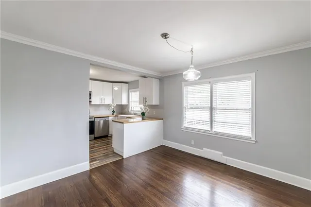 a view of a kitchen and wooden floor