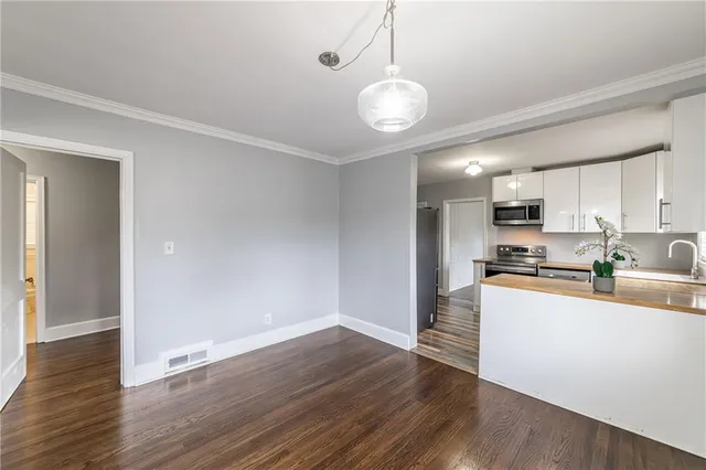 a view of kitchen with wooden floor and window
