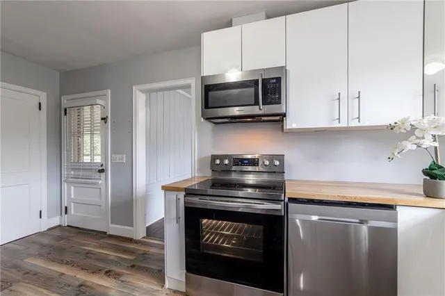 a kitchen with stainless steel appliances a stove a microwave and cabinets