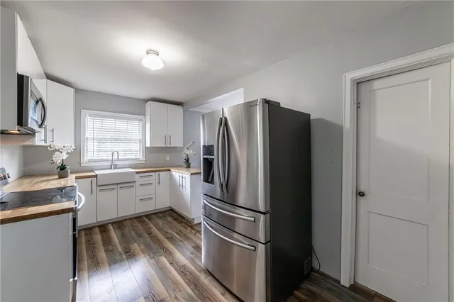 a kitchen with a refrigerator and a sink