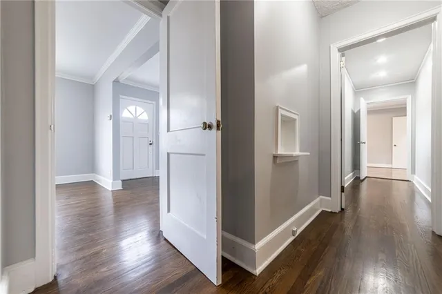 a view of a hallway with wooden floor