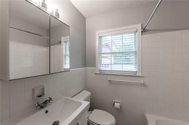 a bathroom with a sink a mirror and a toilet