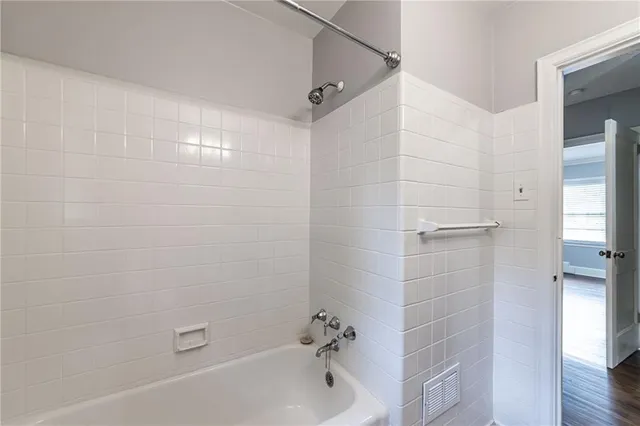 a bathroom with a bathtub and shower