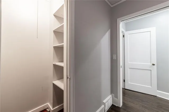 a view of hallway with wooden floor