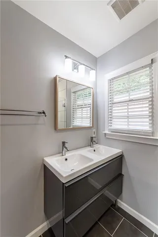 a bathroom with a double vanity sink and mirror