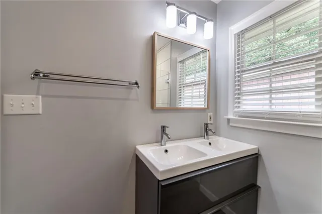 a kitchen with stainless steel appliances wooden floor sink and wooden cabinets