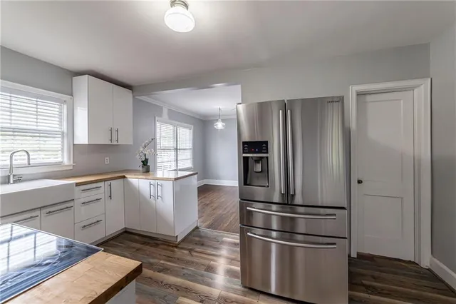 a kitchen with stainless steel appliances a refrigerator sink and cabinets
