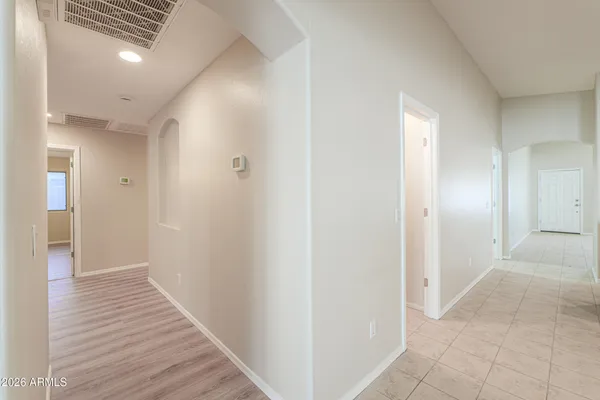 a view of a hallway with wooden floor