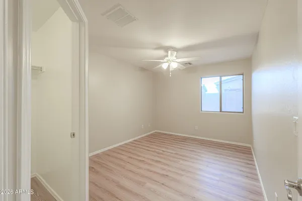 a view of an empty room with wooden floor