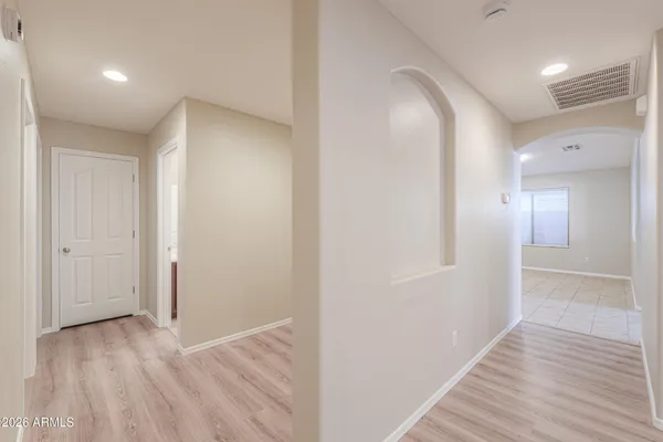 a view of hallway with wooden floor