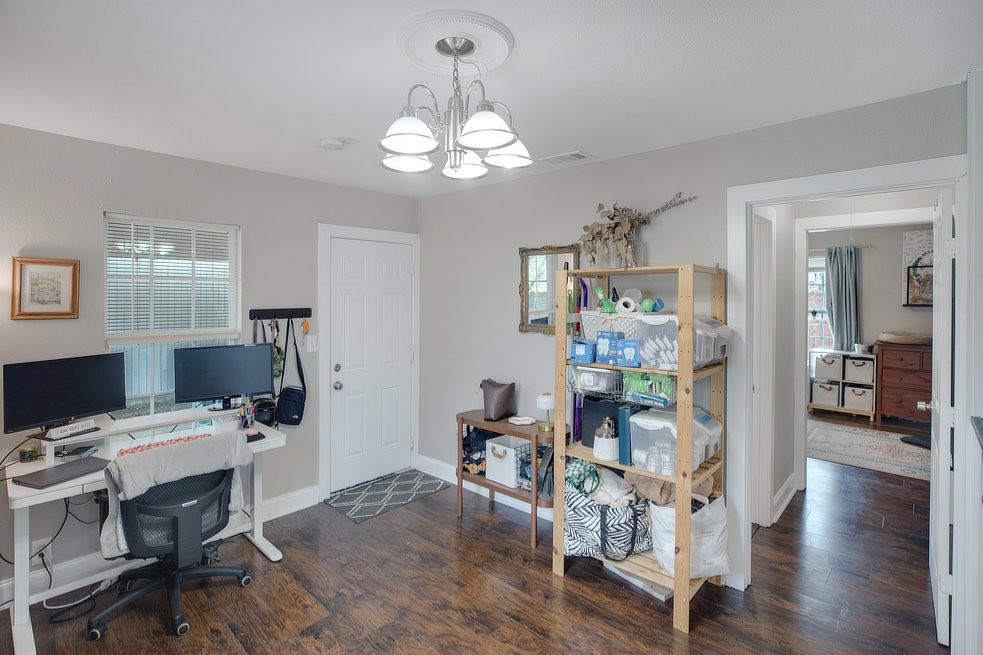 4029 Knox Street Fort Worth, TX 76119 - Photo 14 of 28 a view of a dining room with furniture wooden floor and chandelier
