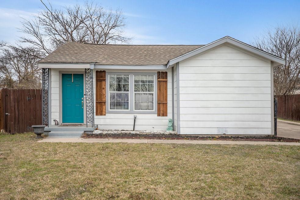 4029 Knox Street Fort Worth, TX 76119 - Photo 23 of 28 a front view of a house with a garden