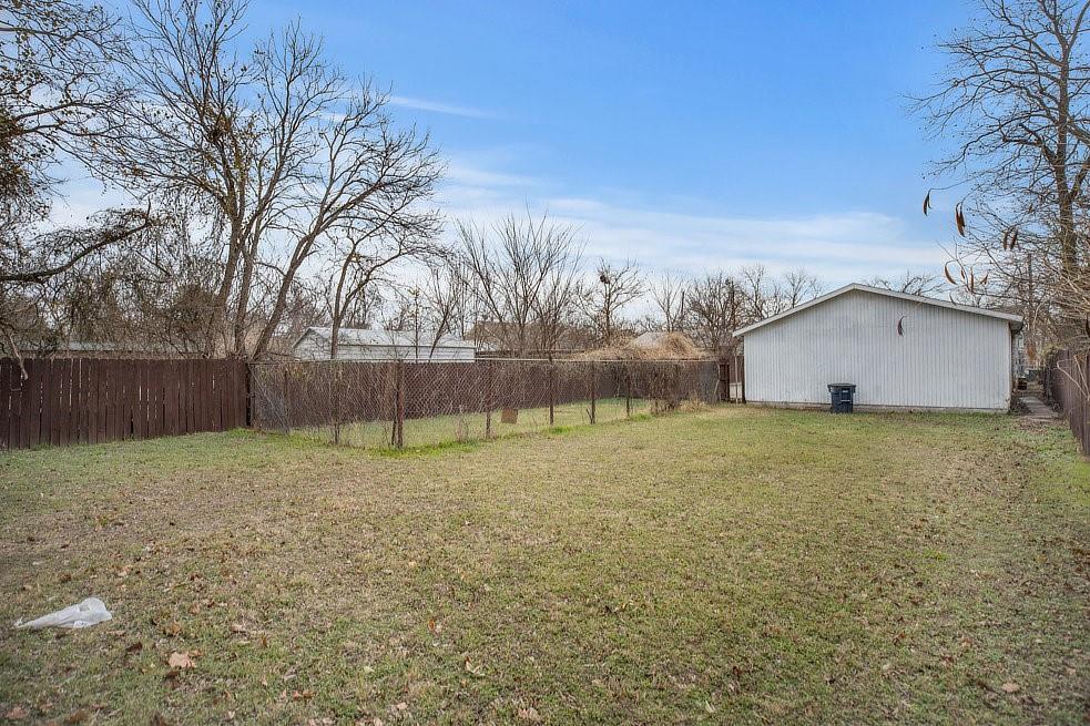 4029 Knox Street Fort Worth, TX 76119 - Photo 24 of 28 a backyard of a house with lots of green space