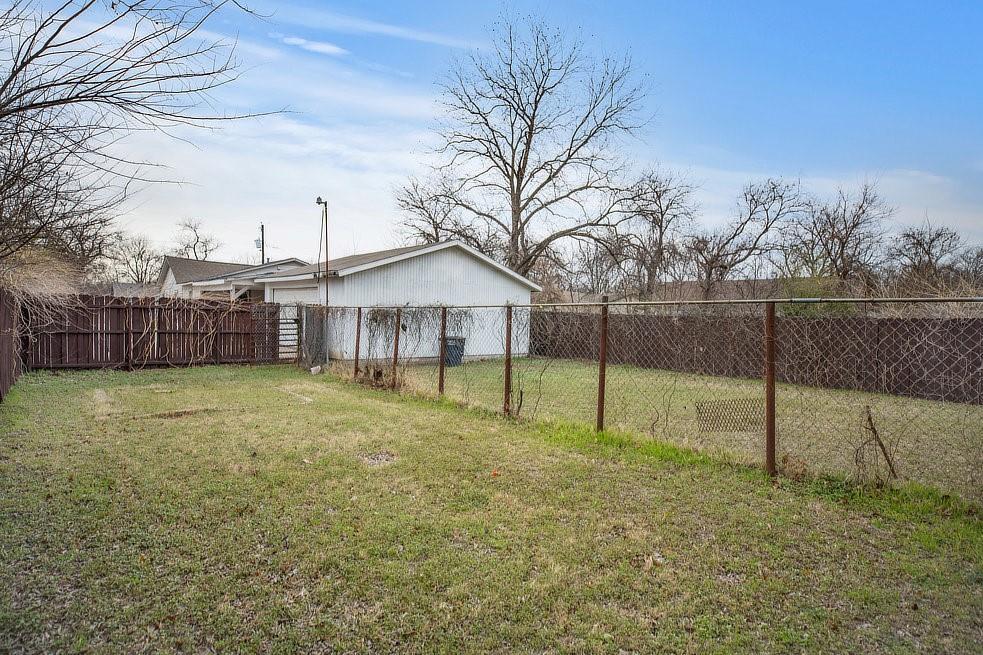 4029 Knox Street Fort Worth, TX 76119 - Photo 26 of 28 a view of a house with backyard and trees