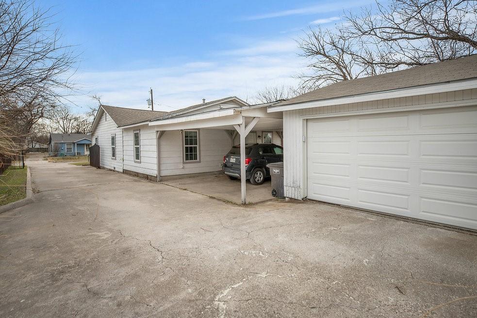 4029 Knox Street Fort Worth, TX 76119 - Photo 3 of 28 a view of a house with a yard and garage