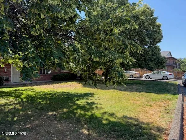 a view of swimming pool with lawn chairs and plants