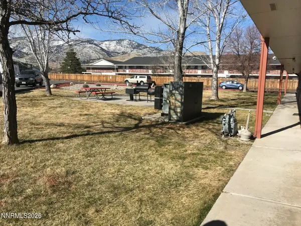a view of a yard with wooden fence