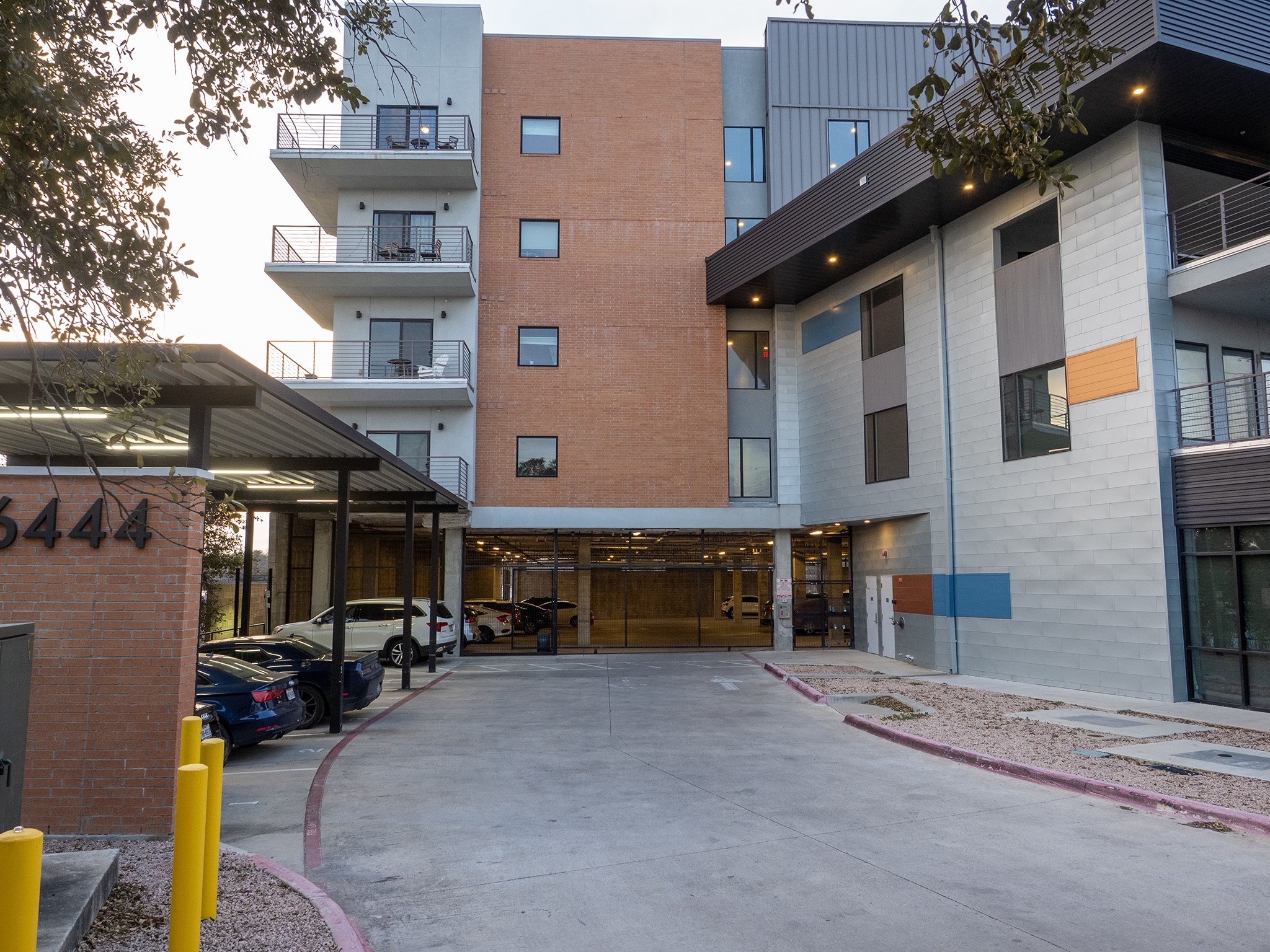 6444 Burnet Road, Unit 509 Austin, TX 78757 - Photo 28 of 32 A contemporary high-rise apartment building features sleek design and integrated covered parking.