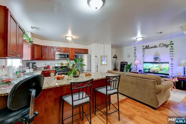 a view of a dining room with furniture and a kitchen