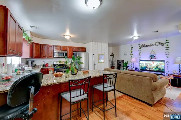 a view of a dining room with furniture and a kitchen