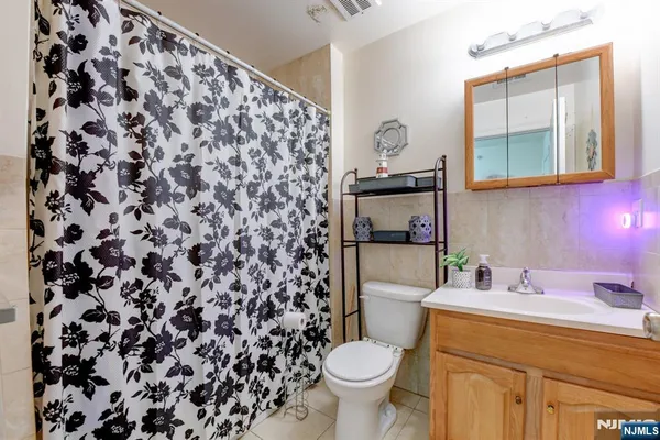 a bathroom with a sink toilet and mirror