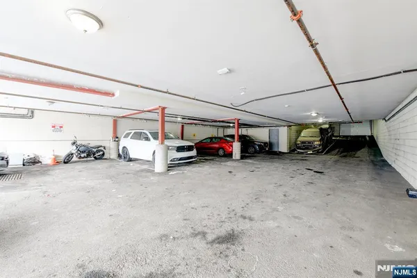 a view of parking garage with cars parked
