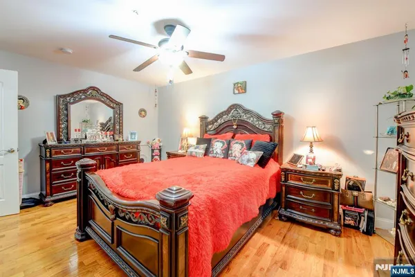 a bedroom with bed and a chandelier