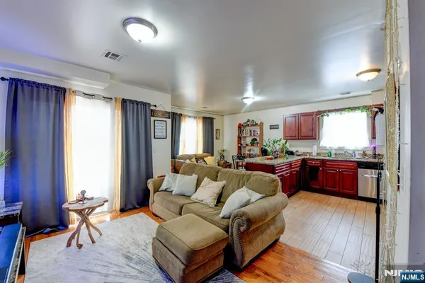 a living room with furniture and a wooden floor