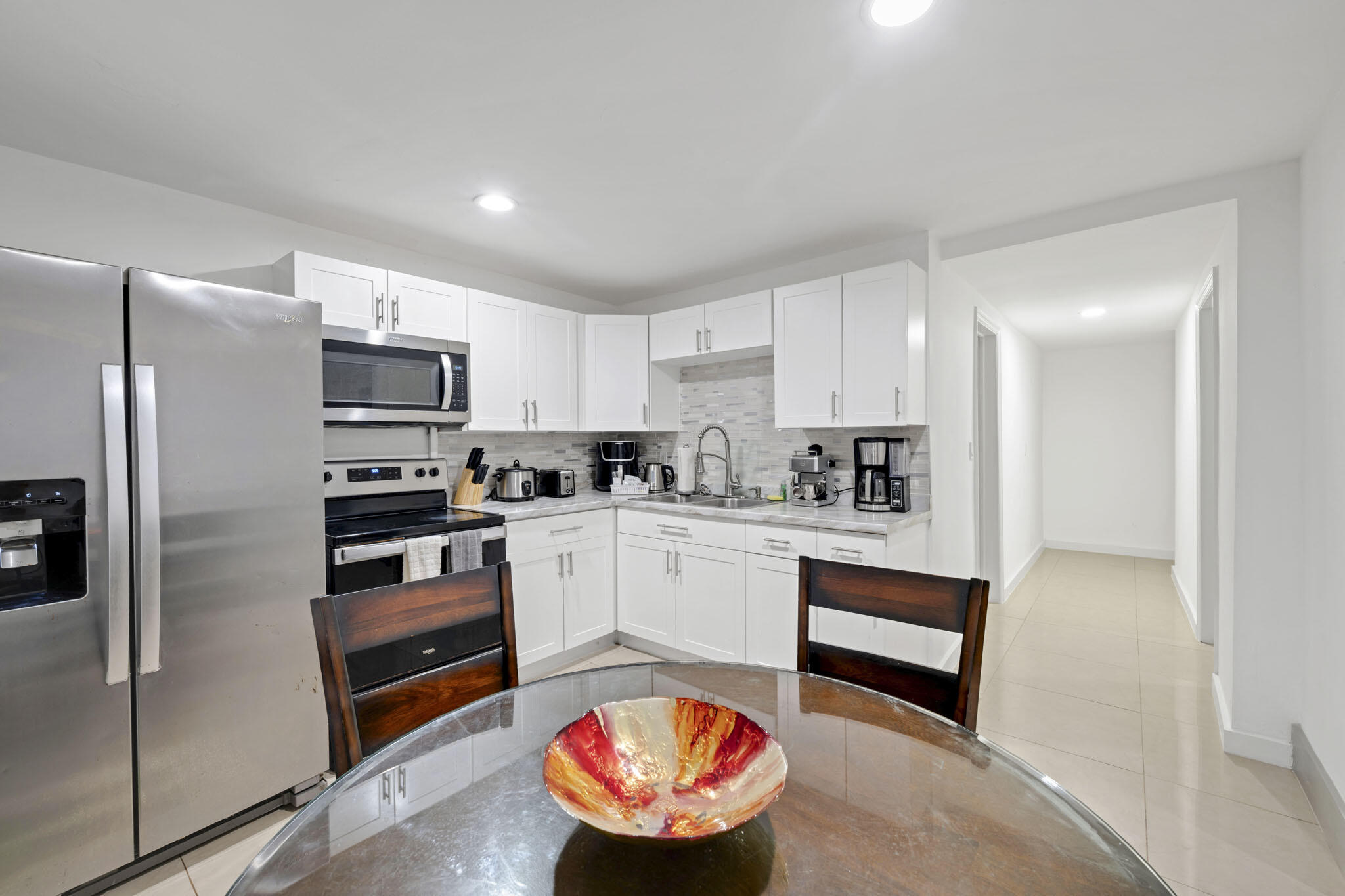 2365 Northwest 68th Street Miami, FL 33147 - Photo 11 of 22 a kitchen with stainless steel appliances granite countertop a refrigerator sink and stove