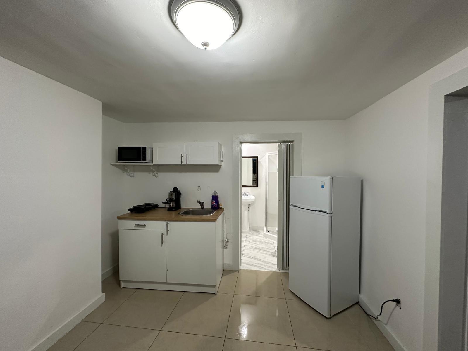 2365 Northwest 68th Street Miami, FL 33147 - Photo 19 of 22 a kitchen with a refrigerator and a stove