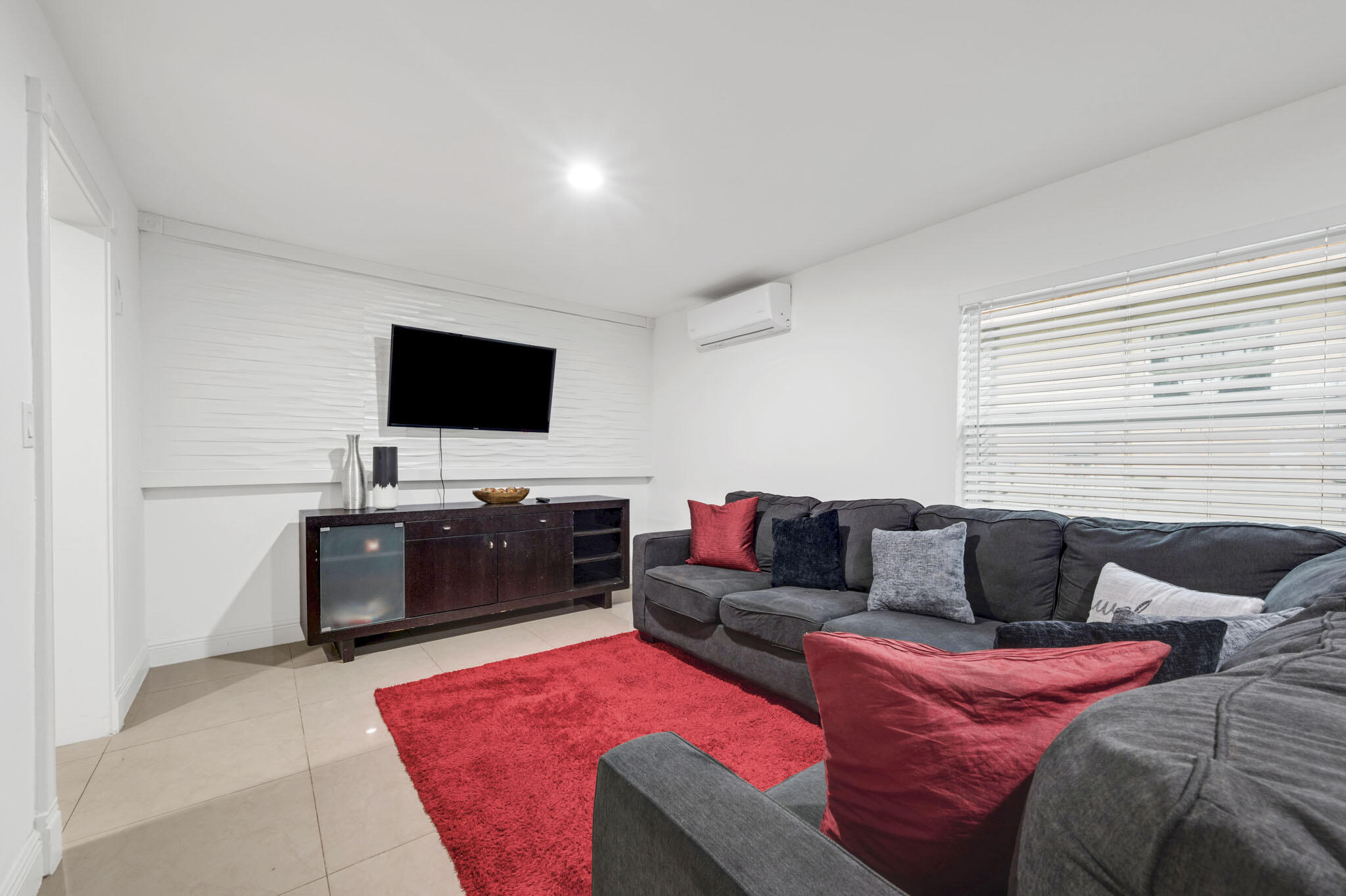 2365 Northwest 68th Street Miami, FL 33147 - Photo 6 of 22 a living room with furniture and a flat screen tv