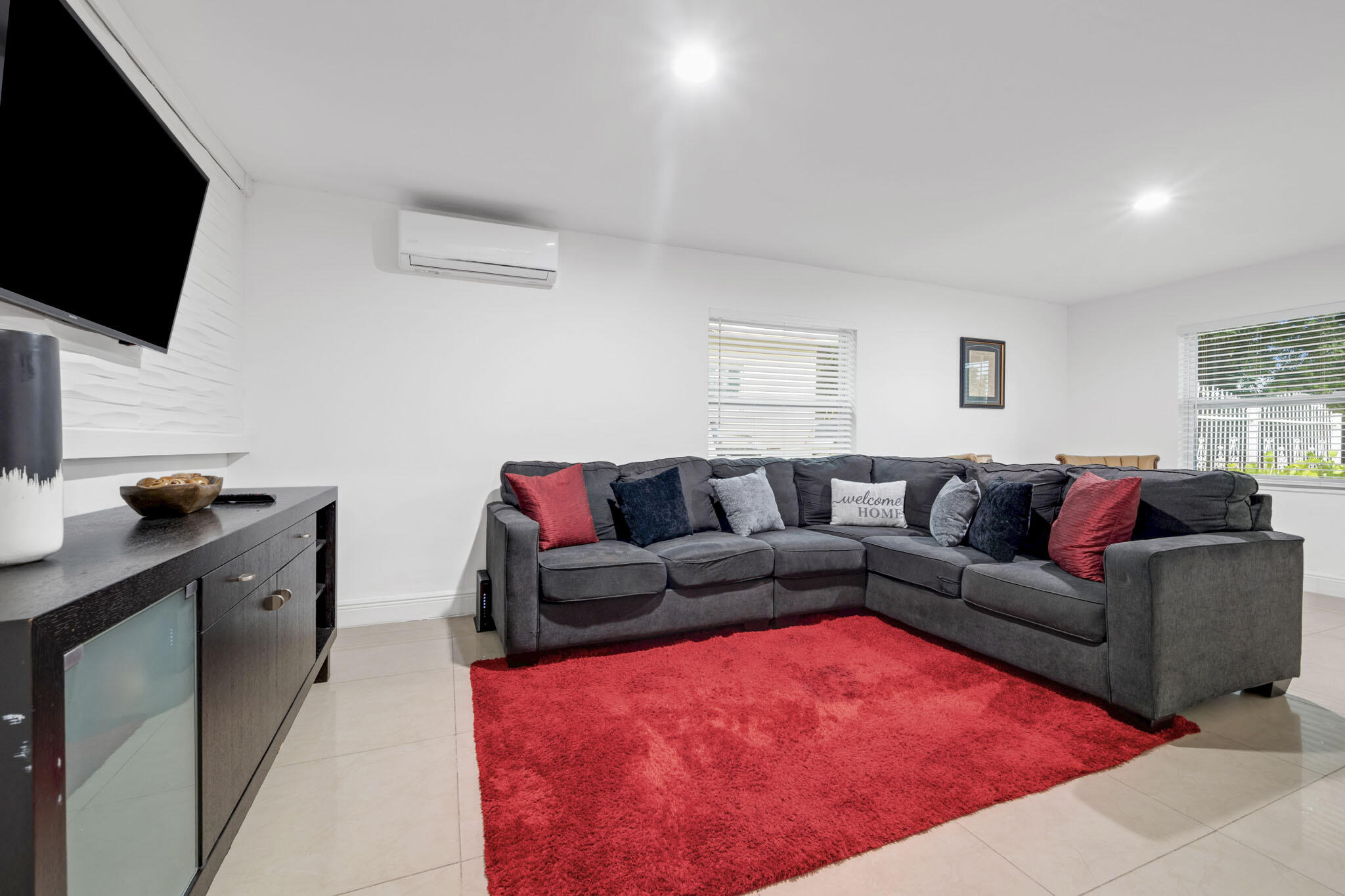 2365 Northwest 68th Street Miami, FL 33147 - Photo 7 of 22 a living room with furniture and a flat screen tv