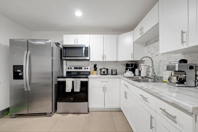 a kitchen with a refrigerator sink and microwave