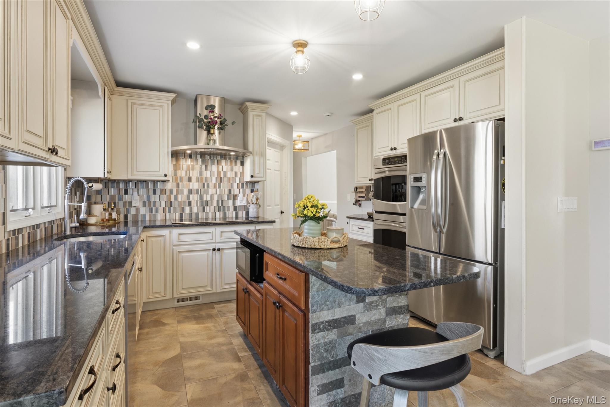 130 Cobb Road Brewster, NY 10509 - Photo 18 of 48 The heart of the home is the well-appointed kitchen, featuring granite countertops, stainless steel appliances, a double wall oven, electric cooktop, and tile flooring